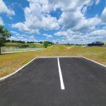 There are two parking spots available for visitors at the north end of the building